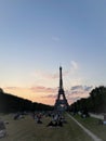 People in the champs de mars park at the foot of the eiffel tower on a summer afternoon in paris france