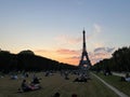 People in the champs de mars park at the foot of the eiffel tower on a summer afternoon in paris france