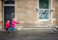 Children chasing pigeons Royalty Free Stock Photo