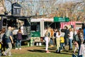 people chatting and eating outdoors at food truck park in the new normal