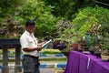 People checking and scoring bonsai on bonsai festival in Kediri