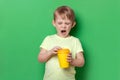 People child kid boy yawn open coffee yellow paper disposable cup. Concept of hard Monday morning, want to sleep, tiredness Royalty Free Stock Photo