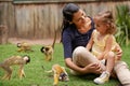 People, child and monkey in nature outdoor at sanctuary or rehabilitation at zoo or animal interaction, environment or Royalty Free Stock Photo