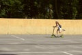 Cute Girl Riding A Scooter In The Park.