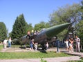 People children playing near the monument military combat aircraft in the Park in the summer