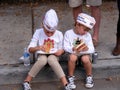 People, Children siting on curb with Hot Dogs