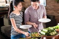 People choosing food at Indonesian buffet in restaurant