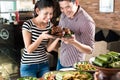 People choosing food at Indonesian buffet in restaurant