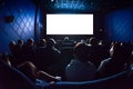 People in the cinema watching a movie. Blank empty white screen