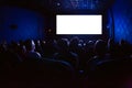 People in the cinema watching a movie. Blank empty white screen