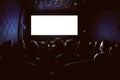 People in the cinema watching a movie. Blank empty white screen