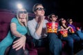 People in the cinema wearing 3d glasses