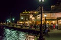 People, Citizens and Tourists Walking Along Old Chania Port with Bars and Clubs by the Sea. Summer Night Scene in Crete, Greece