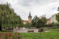 People in a city park and the New Town Hall in Prague