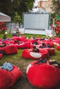 people at city public park watching movie at open air cinema