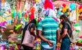 People in City Street Market Stall buying powder dry colors and pichkari on Holi Festival occasion. Holi is Famous Festival of Royalty Free Stock Photo