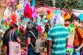 People in City Street Market Stall buying powder dry colors and pichkari on Holi Festival occasion. Holi is Famous Festival of Royalty Free Stock Photo