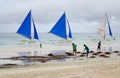 People clean the beach in Boracay, Philippines