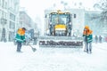 People cleaning city streets after snowstorm