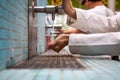 People cleaning hands and using tap water in a kitchen sink.
