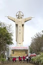 People climb to the giant statue of Jesus Christ atop mount Nyo. Vung Tau, Vietnam