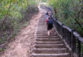 People climb up long staircase