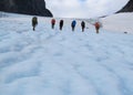 People climbers, climbing snow summit, rocky mountain peaks and glacier in Norway