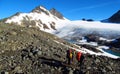 People climbers, climbing to the summit, rocky mountain peaks and glacier in Norway