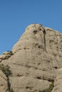 People climbing with ropes and climbing equipment one of the famous spiers of the mountain of Montserrat