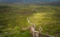 People climbing on steep stairs of wooden boardwalk, to reach Cuilcagh Mountain peak Royalty Free Stock Photo