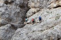 People climbing the Via Ferrata Severino Casara with bridge in Sexten Dolomites mountains, South Tyrol