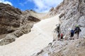 People climbing the Via Ferrata Severino Casara and snow field in Sexten Dolomites mountains, South Tyrol Royalty Free Stock Photo