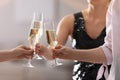People clinking glasses of champagne against blurred background, closeup Royalty Free Stock Photo