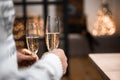 People clinking glasses of champagne against blurred background, closeup. Bokeh effect Royalty Free Stock Photo