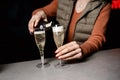 People clinking glasses of champagne against blurred background, closeup. Bokeh effect Royalty Free Stock Photo