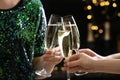 People clinking glasses of champagne on blurred background Royalty Free Stock Photo