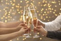 People clinking glasses of champagne on blurred background Royalty Free Stock Photo