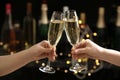 People clinking glasses of champagne on blurred background Royalty Free Stock Photo