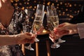 People clinking glasses of champagne indoors, closeup Royalty Free Stock Photo