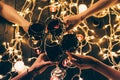 People clinking glasses over fairylights Royalty Free Stock Photo