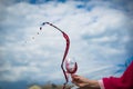 People clinking glasses with wine on the summer terrace of cafe or restaurant