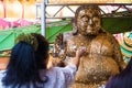 People closed gold leaf on Buddha