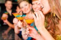 People in club or bar drinking cocktails Royalty Free Stock Photo