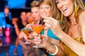 People in club or bar drinking cocktails Royalty Free Stock Photo