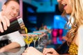 People in club or bar drinking cocktails Royalty Free Stock Photo