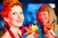 People in club or bar drinking cocktails