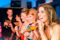 People in club or bar drinking cocktails Royalty Free Stock Photo