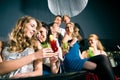 People in club or bar drinking cocktails Royalty Free Stock Photo