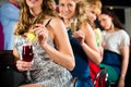 People in club or bar drinking cocktails Royalty Free Stock Photo