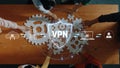 People Collaborating on Digital Security Concept with VPN Shield and Gears on Table for Cyber Protection and Remote Royalty Free Stock Photo